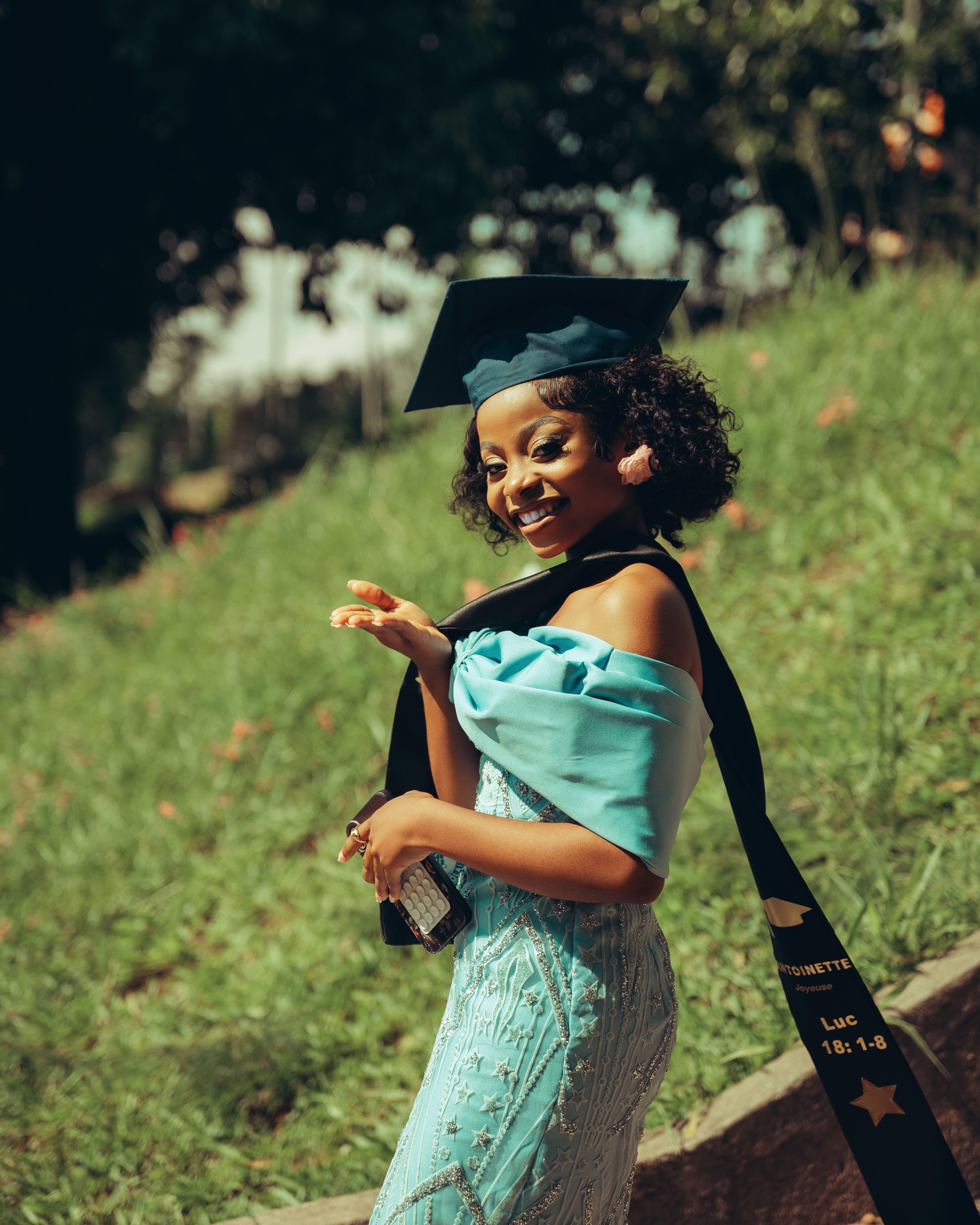 Joyful Graduate in Cap and Gown Outdoors · Free Stock Photo