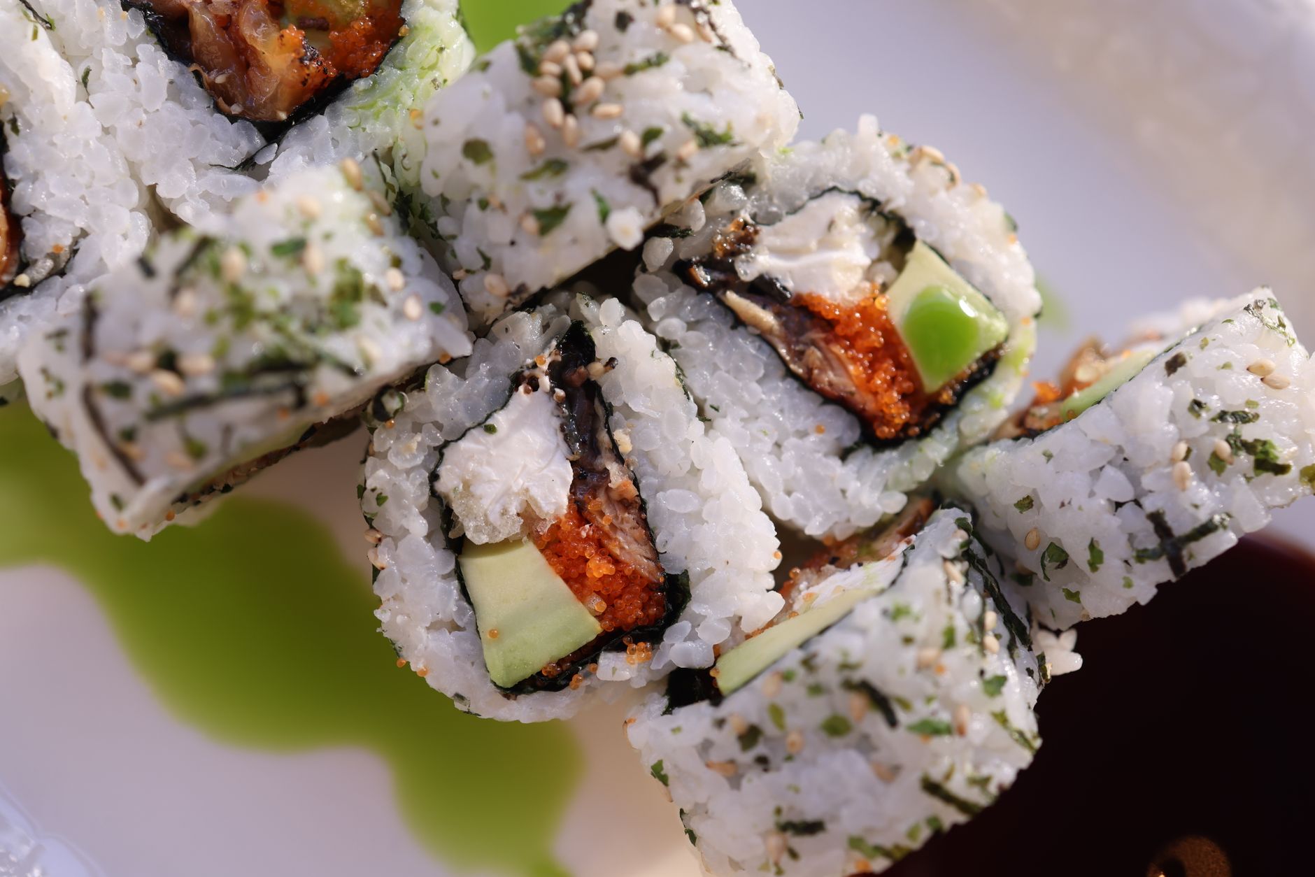 Chef preparing sushi rolls in kitchen