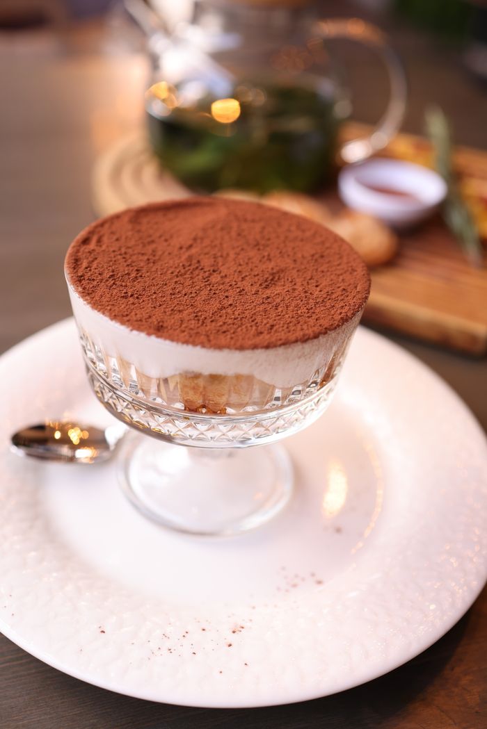 Tiramisu in a glass cup dusted with cocoa