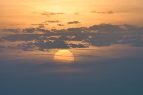Free Beautiful sunrise over Poprad with sun partially hidden by clouds. Stock Photo