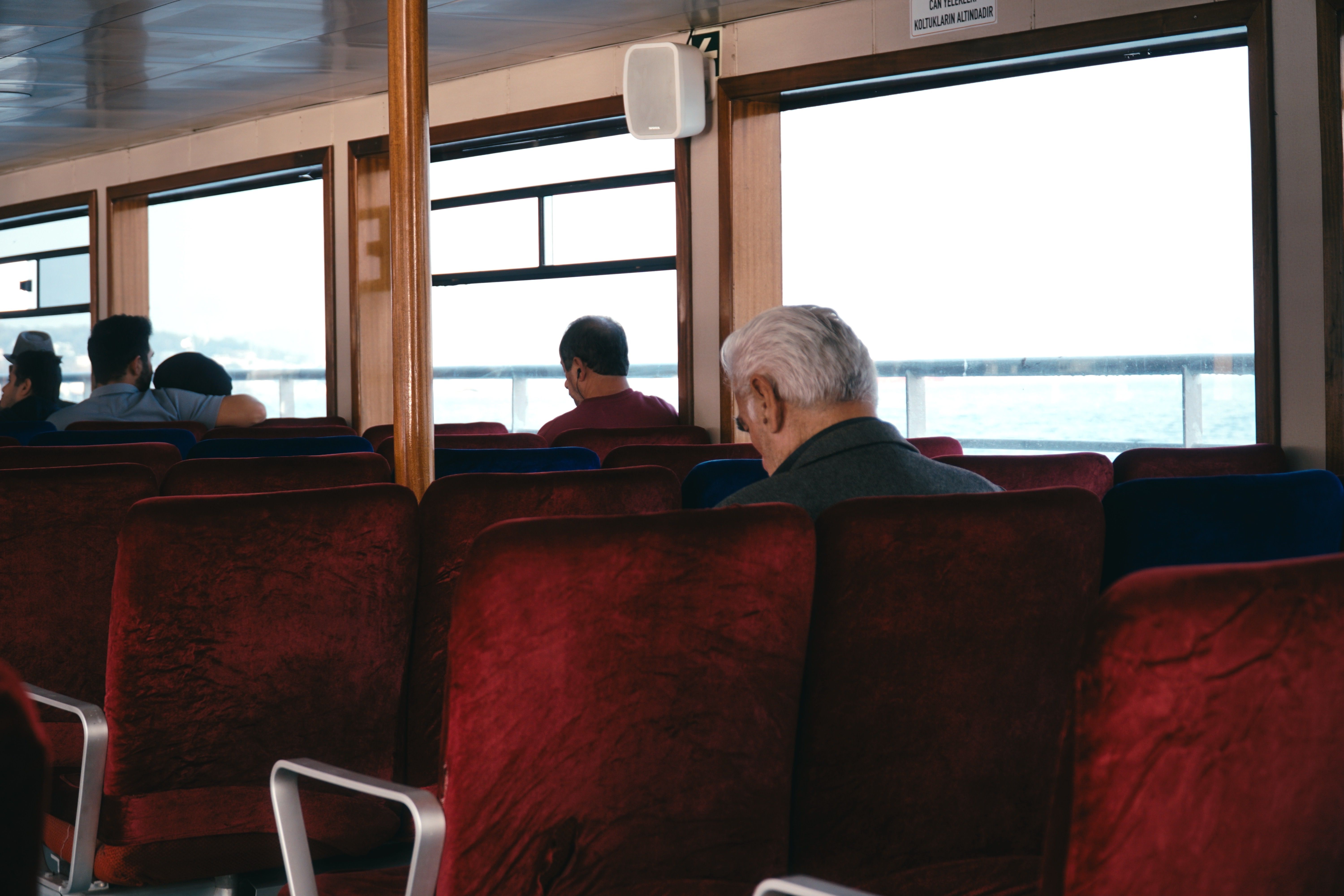 Passengers Relaxing on a Ferry Interior Journey · Free Stock Photo
