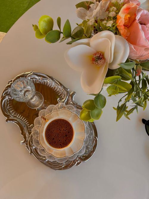 Free Elegant coffee setting on ornate tray with flowers, evoking sophistication. Stock Photo