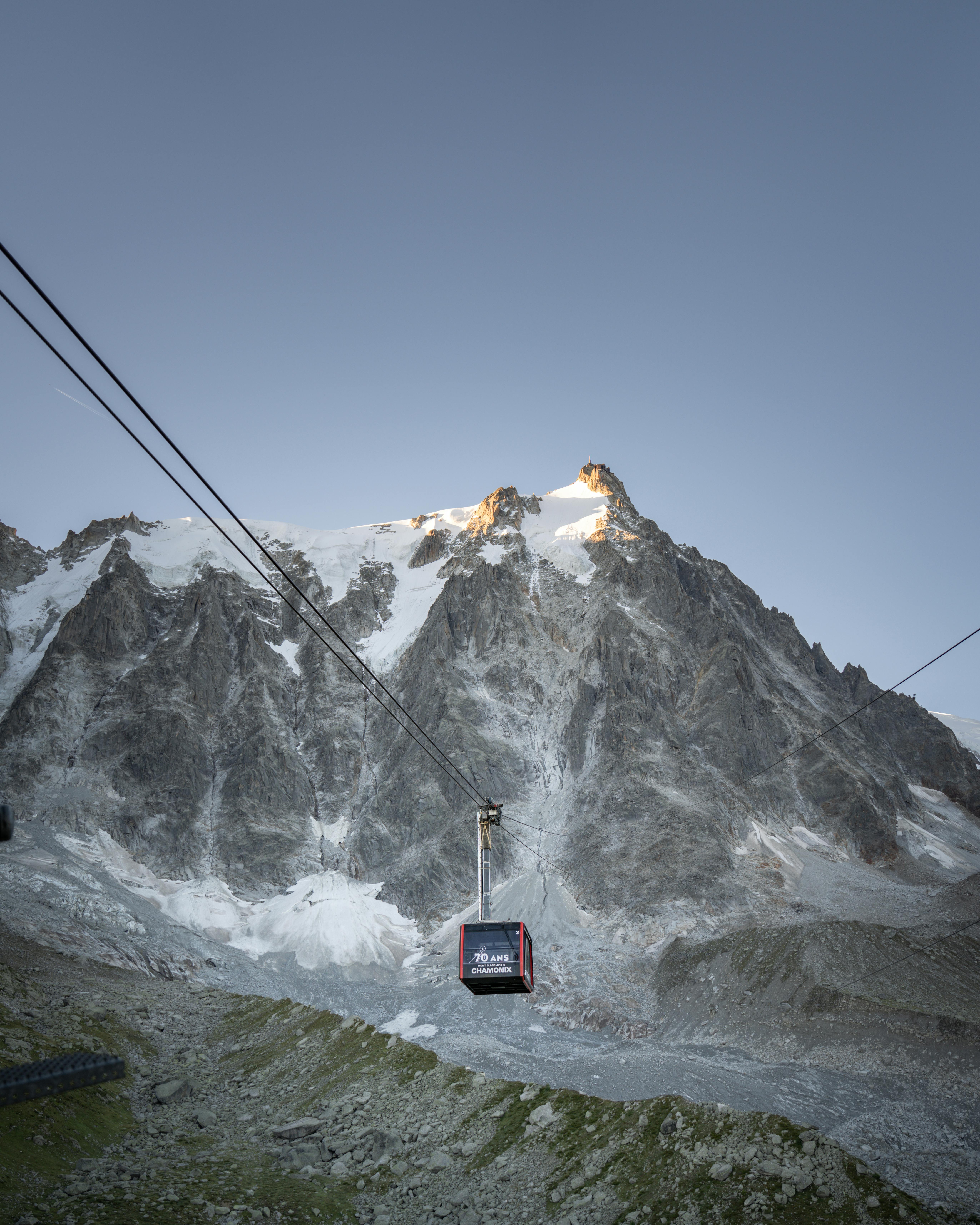 Majestic view of a ski gondola against the rugged peaks of Chamonix, France.