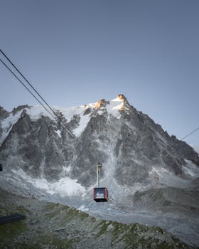 Majestic view of a ski gondola against the rugged peaks of Chamonix, France.