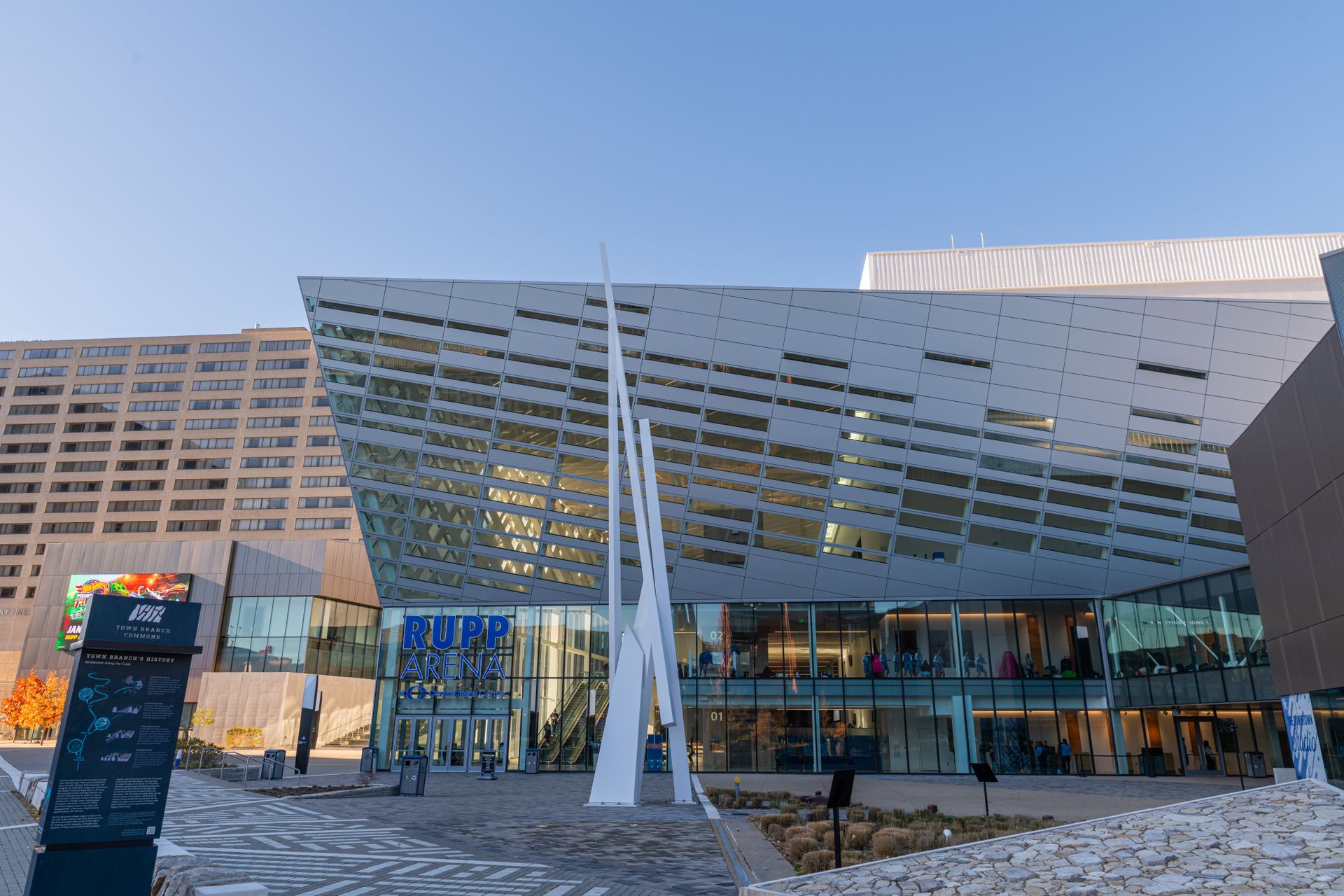 Modern exterior of Kay Bailey Hutchison Convention Center in Dallas with distinctive white architectural features and glass facade, clear blue sky, daytime