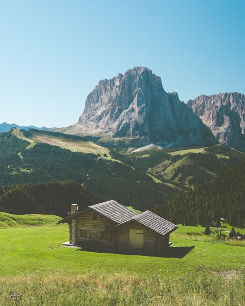 Free Breathtaking landscape of Seceda and Dolomites with a wooden cabin in Italy's summer. Stock Photo