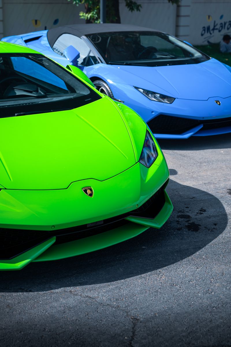Vibrant green and blue sports cars parked outdoors in Ankara, Türkiye.