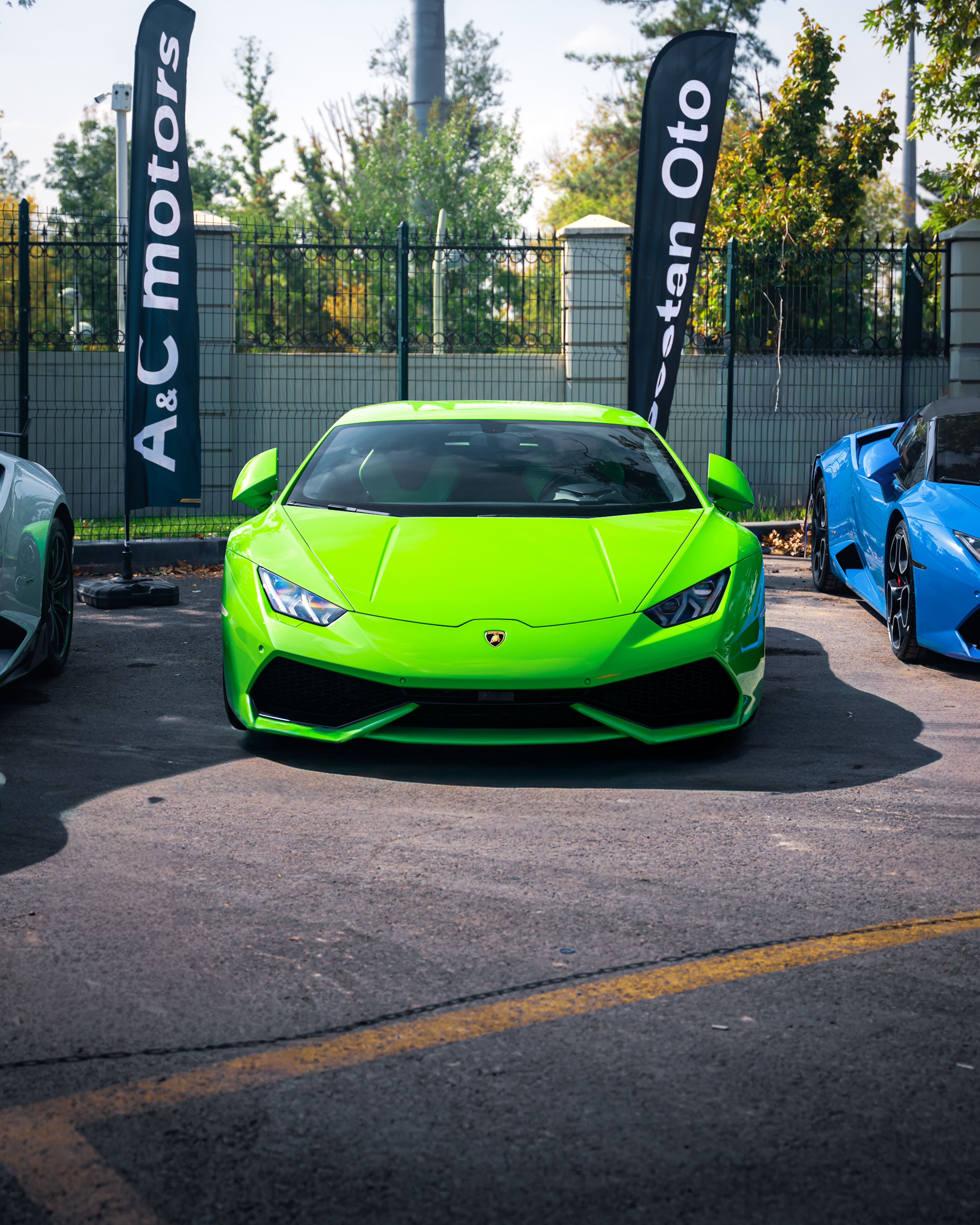 A sleek green sports car parked outdoors at a dealership in Ankara, Türkiye.
