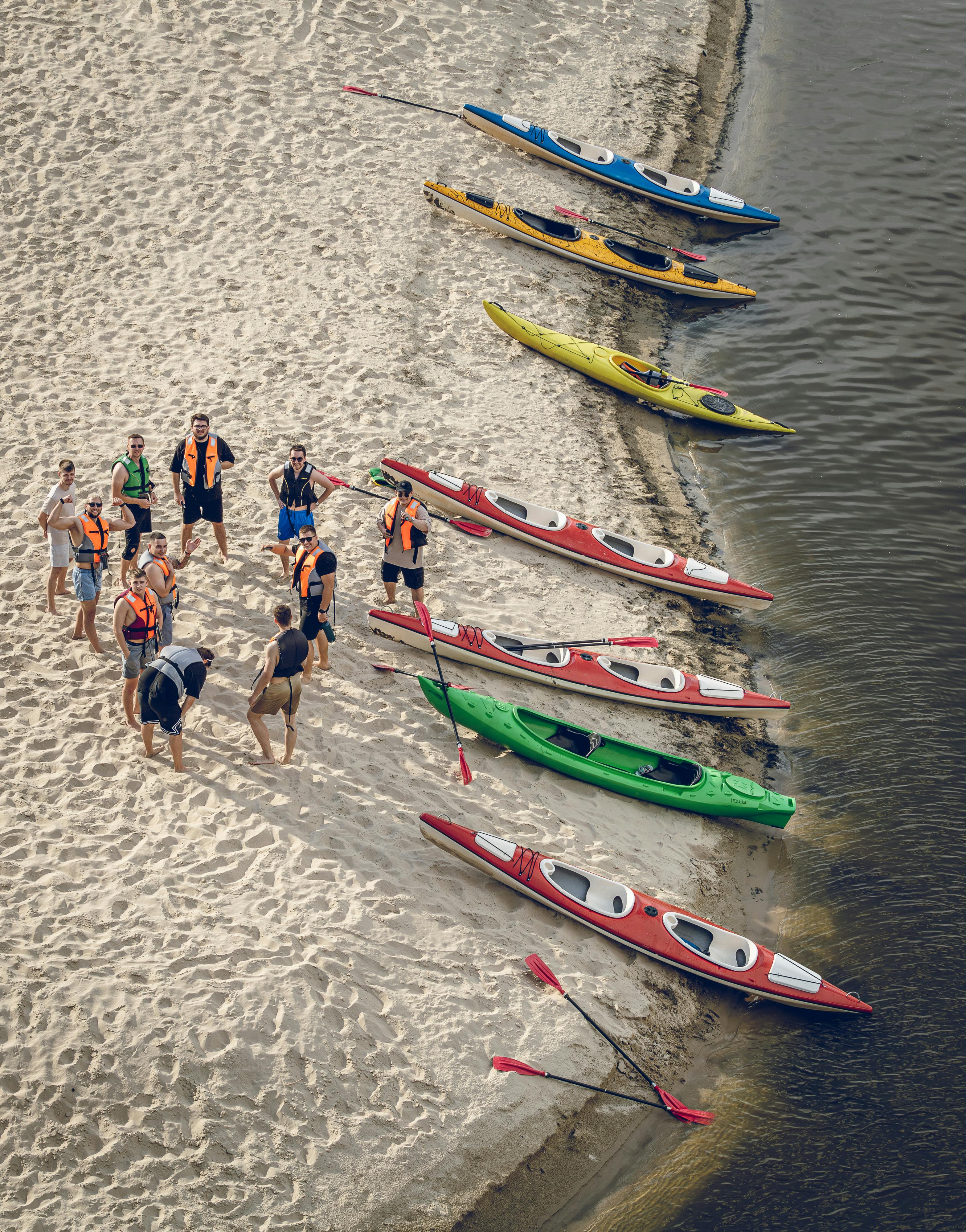 Colourful sit-on-top kayaks lined up on the sand at Pasir Ris Beach Park Singapore with calm coastal water