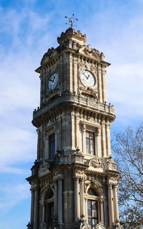 Free A towering clock tower with intricate architecture against a clear blue sky, showcasing classic design. Stock Photo