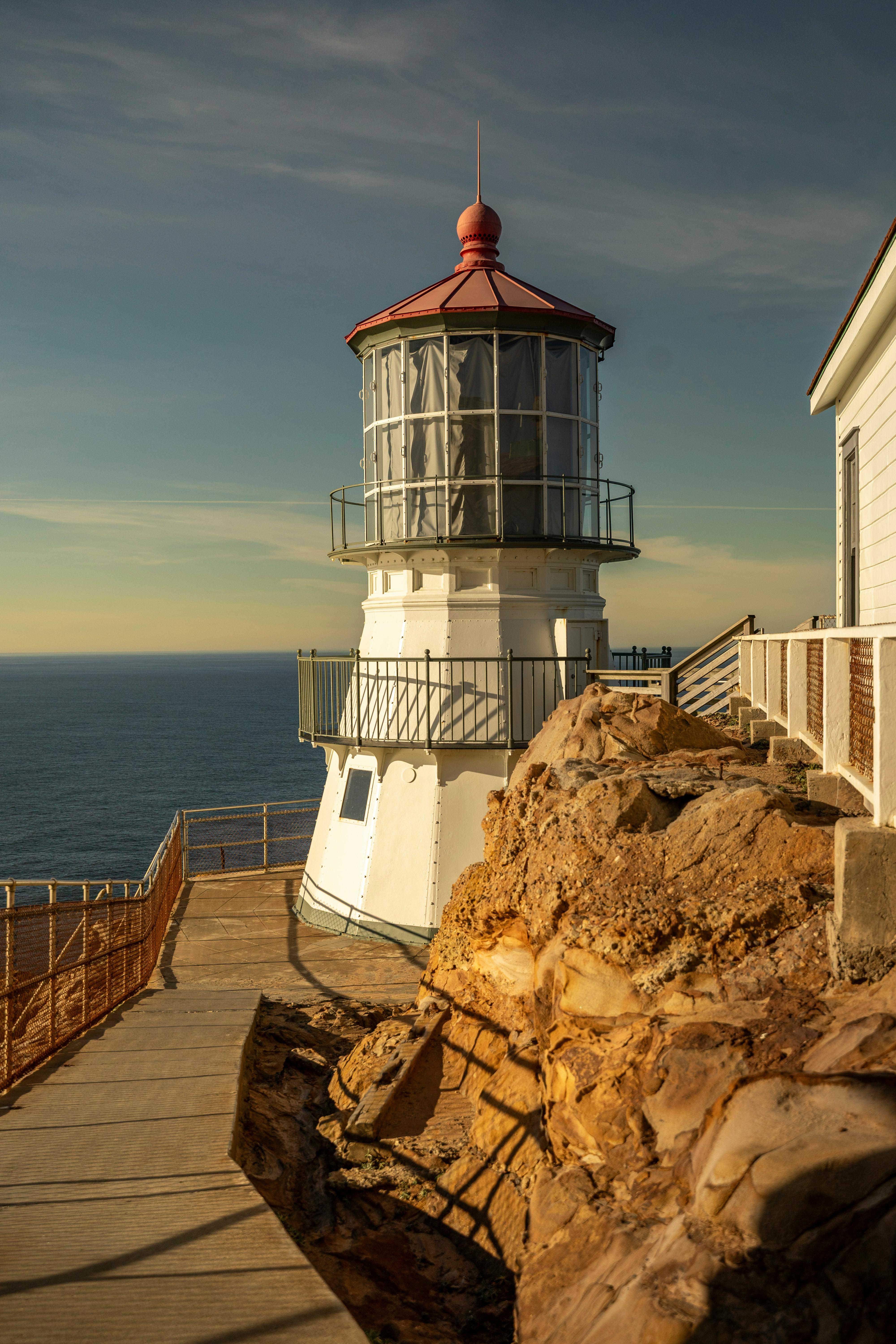 Dramatic coastal lighthouse scene at Point Reyes with rocky landscape.