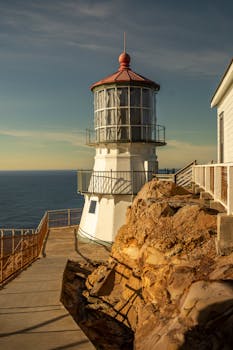 Dramatic coastal lighthouse scene at Point Reyes with rocky landscape.