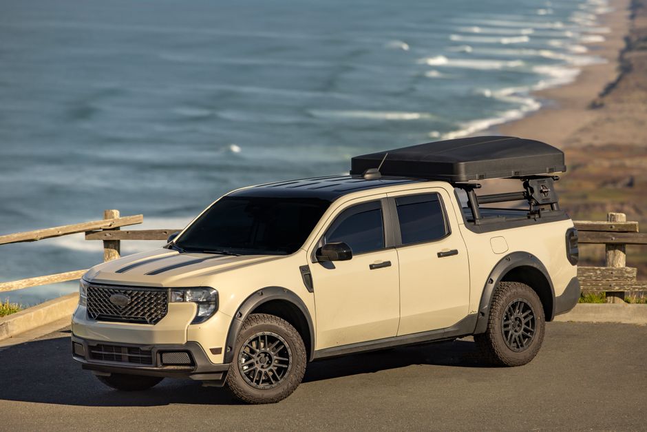 A rugged off-road vehicle parked by the ocean, showcasing adventure and exploration in a coastal setting.