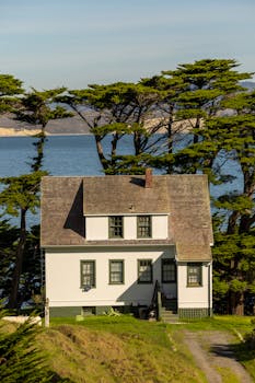 Charming white house by sea with scenic ocean view. Ideal nature and travel setting.