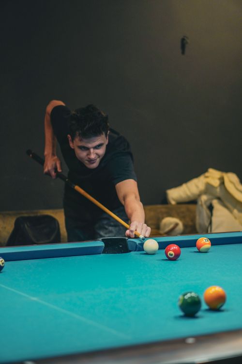 Free Focused man aiming in a billiards game indoors, Kyiv, Ukraine. Stock Photo