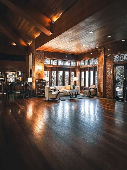 Panelled timber lounge under low warm light — photo by Azli Nawawi on Pexels