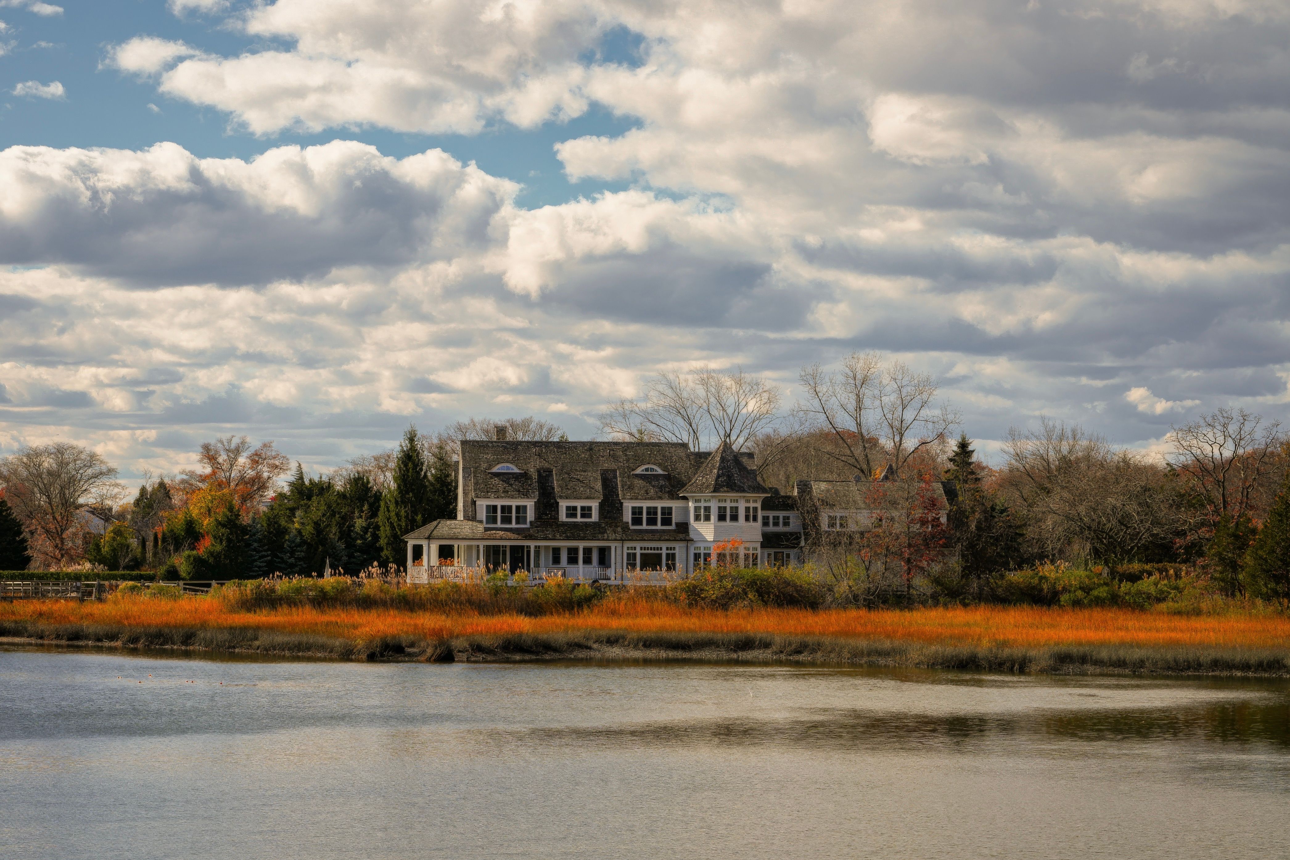 Charming Riverside House in Fall Landscape · Free Stock Photo