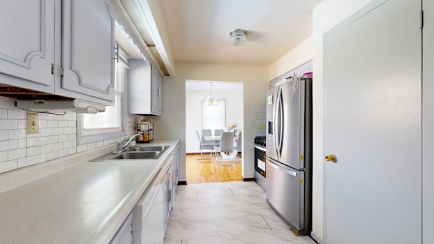 Bright kitchen with stainless steel appliances and dining area.