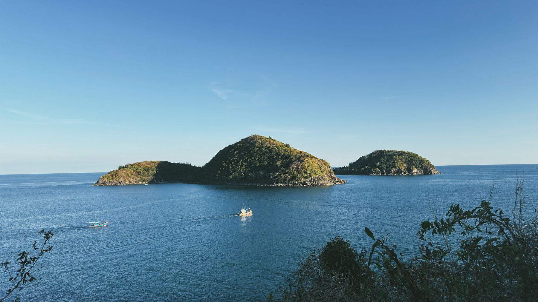 Beautiful scenic view of islands at Phu Quoc, Vietnam with boats under a clear blue sky.