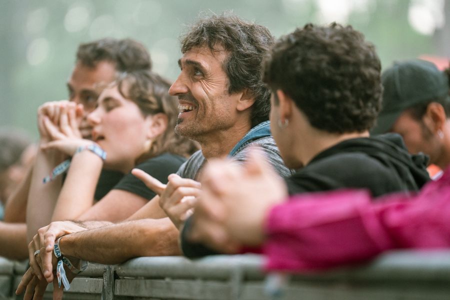 Friends laughing together in a festival crowd — photo by Noland Live on Pexels