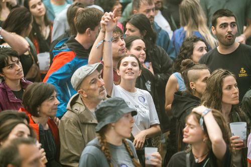 Free A diverse crowd enjoying an outdoor festival with various expressions and interactions. Stock Photo