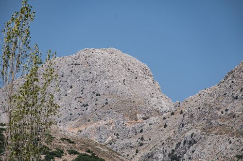 Free A stunning mountainscape with rocky terrain under a vivid blue sky. Stock Photo
