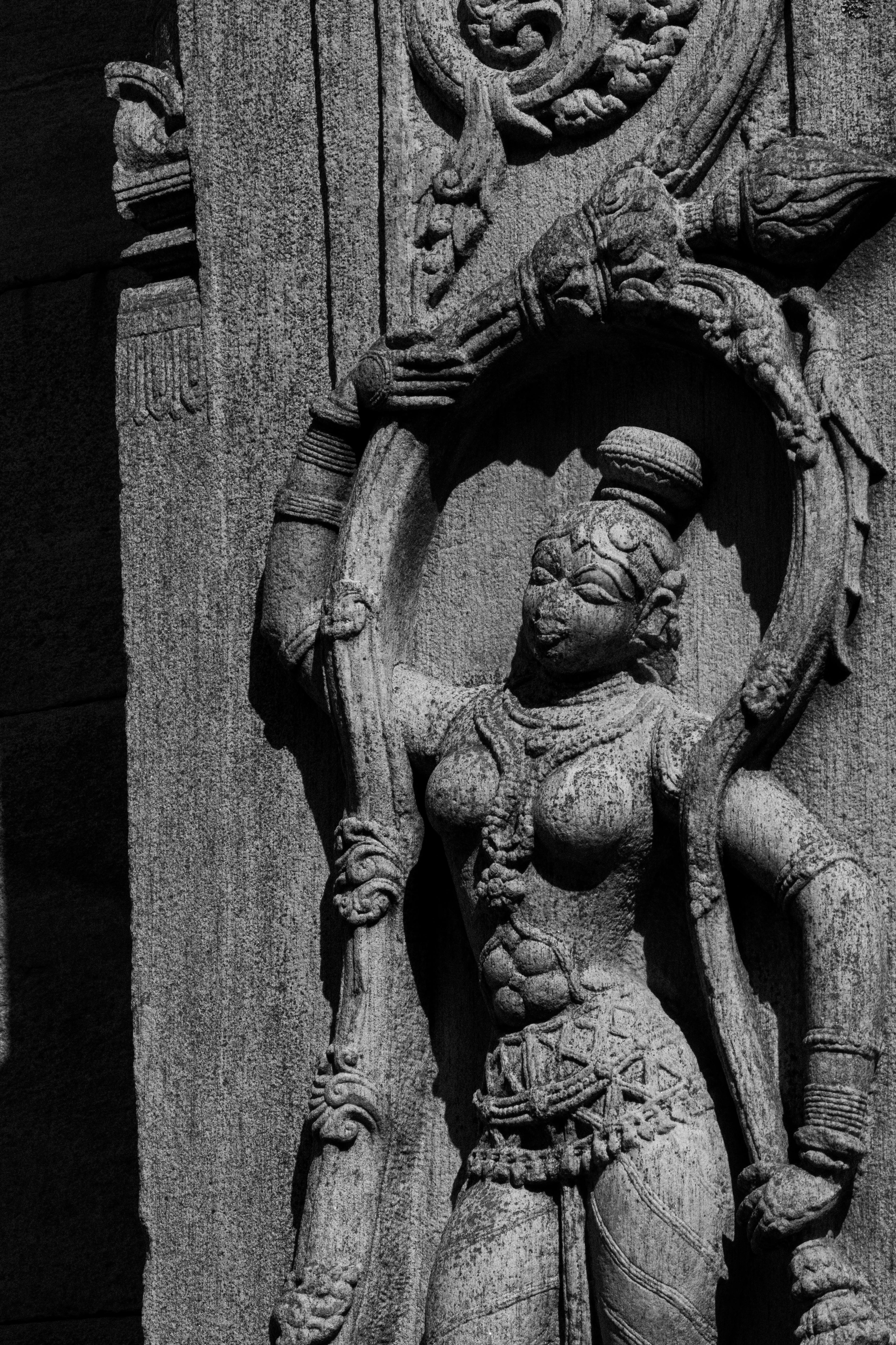Detailed black and white stone carving of a deity at Melukote Temple, depicting rich heritage craftsmanship.