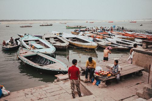 Free A vibrant scene of boats and people at the ghats of Varanasi, India during the day. Stock Photo