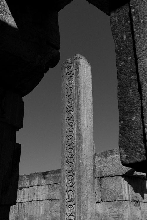 Free Black and white photo of an ancient stone pillar in Melukote, Karnataka. Stock Photo