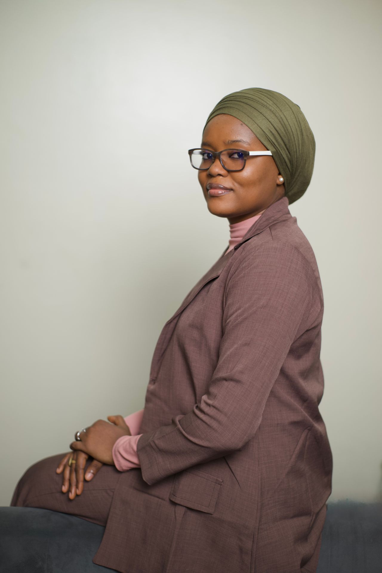 Kenyan professional woman in modest formal attire, representing Wakenya working in the UAE