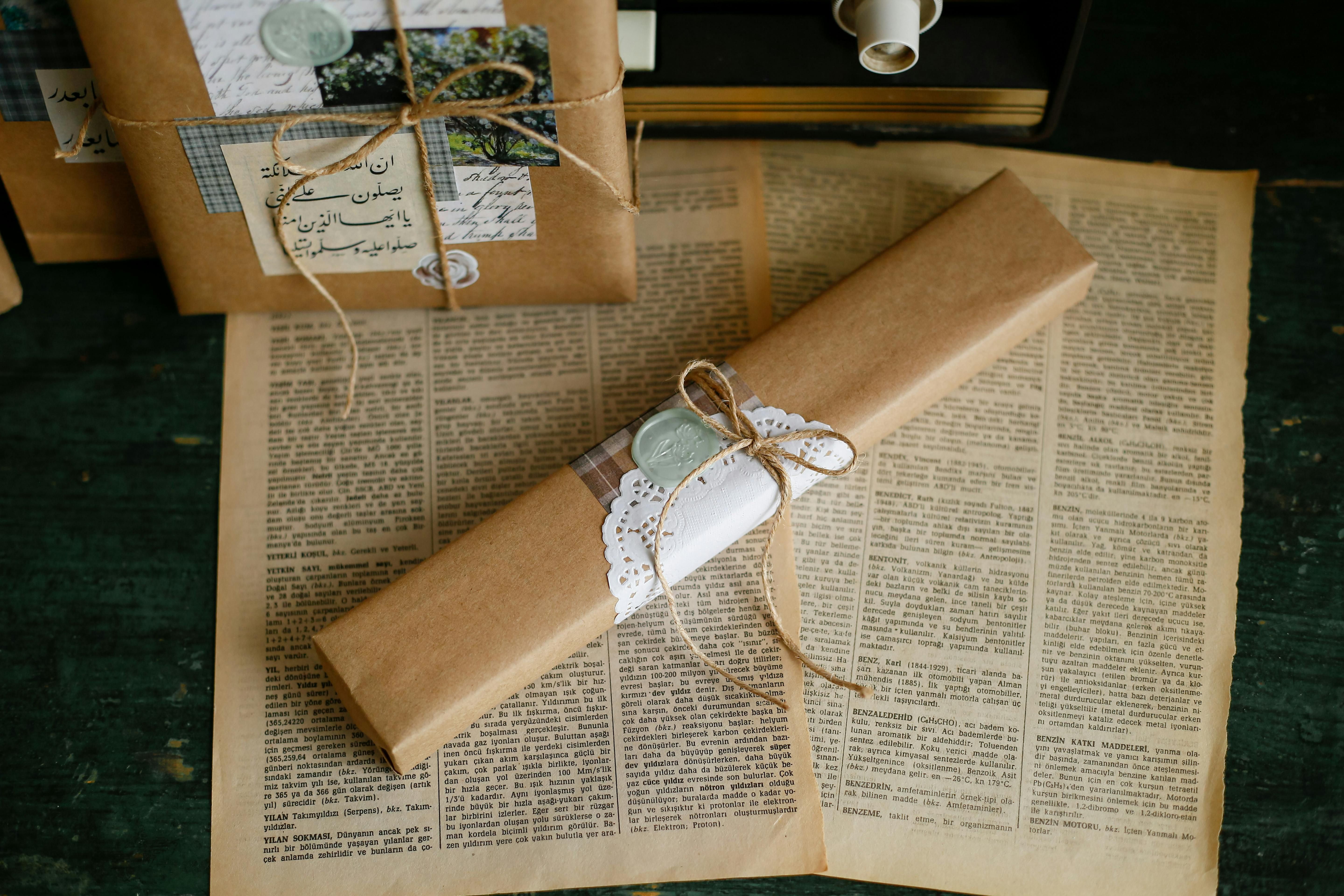 Vintage Wrapped Gifts on Old Pages · Free Stock Photo