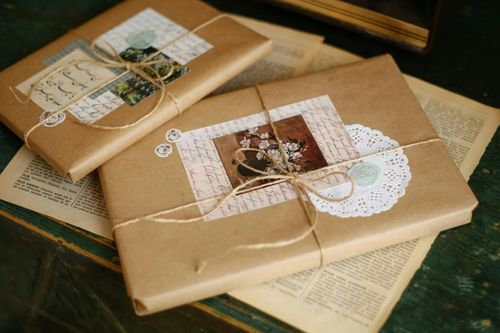 Free Beautifully wrapped vintage gift packages with decorative elements on a wooden table. Stock Photo