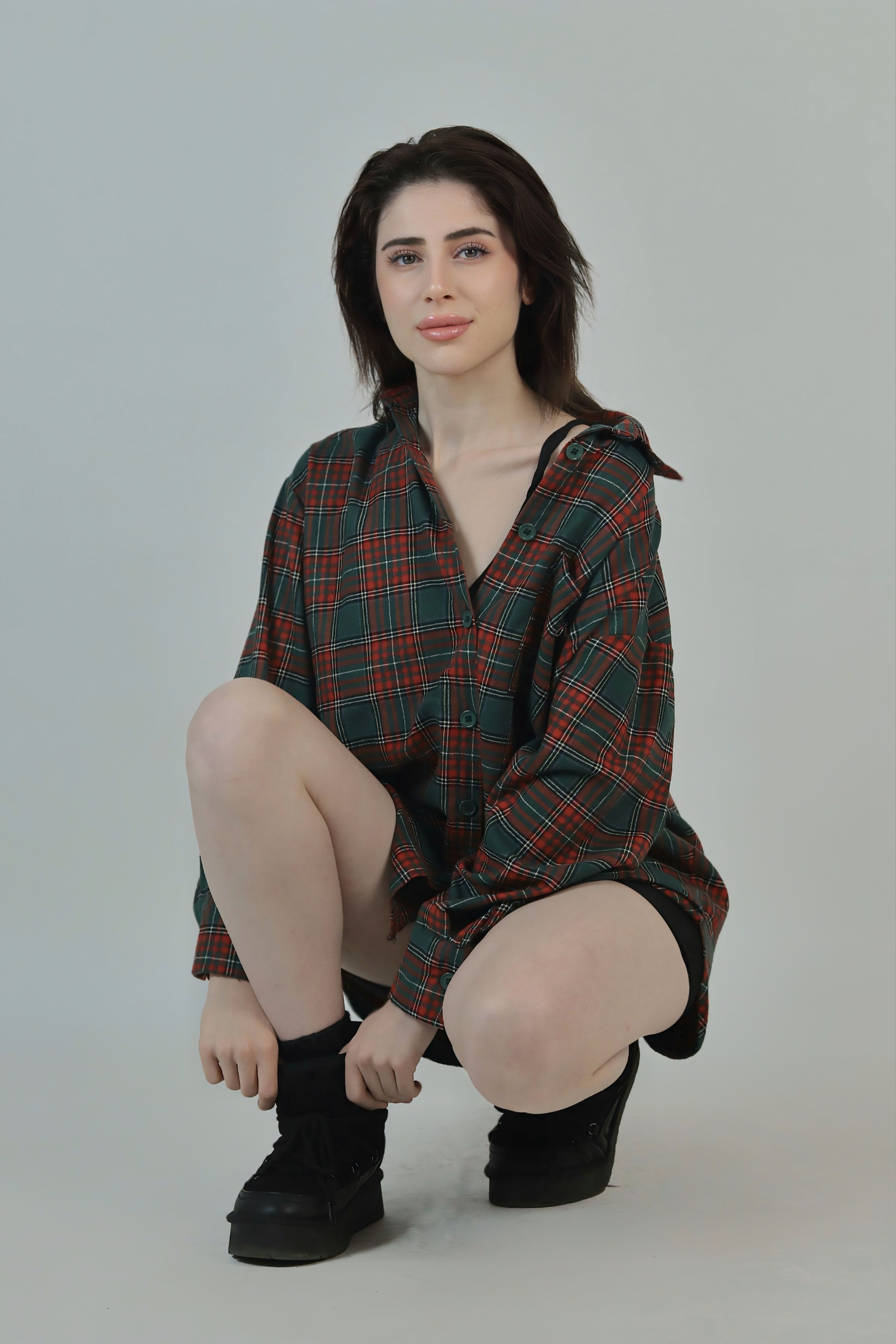 Young Woman in Plaid Shirt Posing in Studio · Free Stock Photo