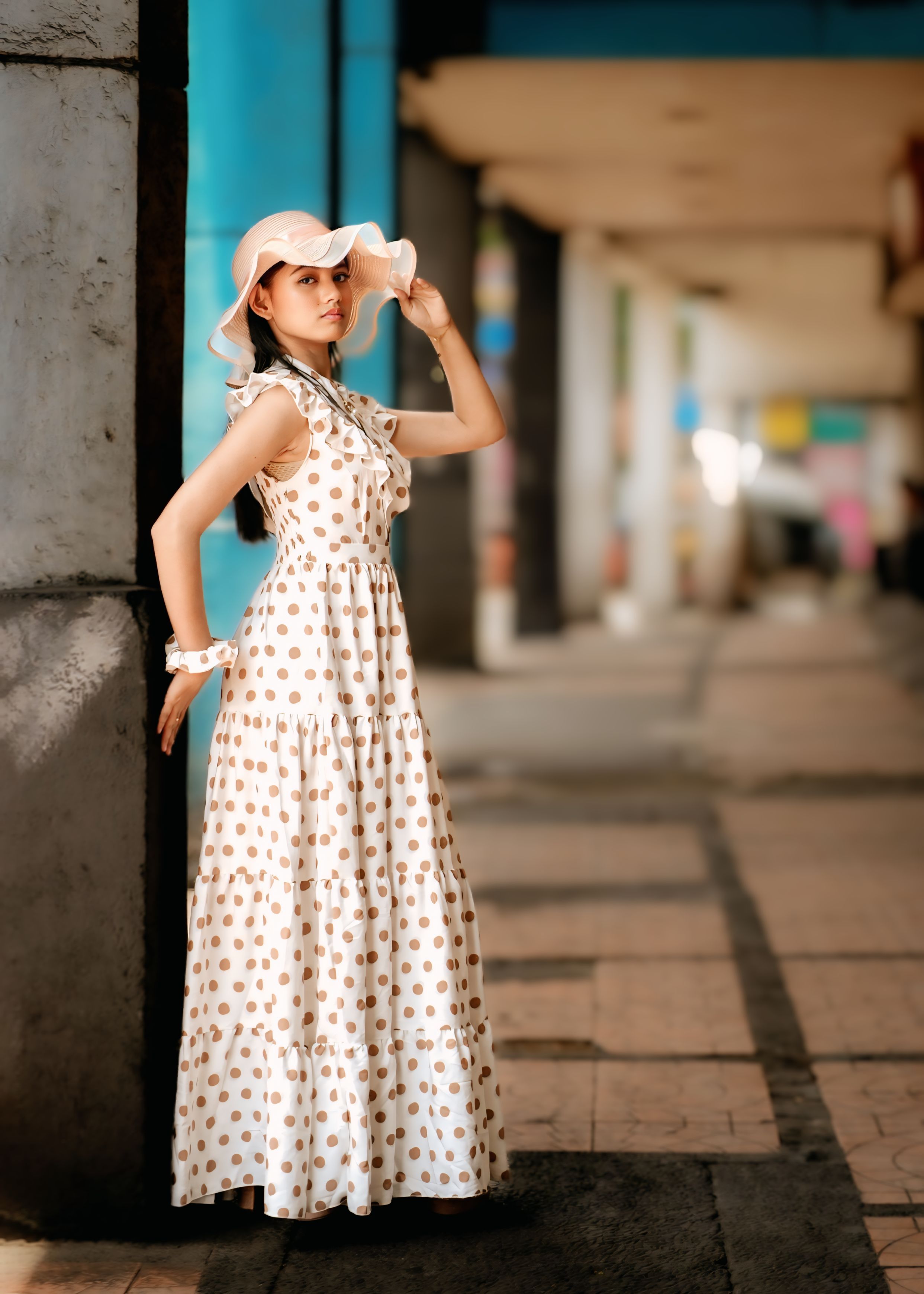 Stylish Woman Posing in Polka Dot Dress Outdoors · Free Stock Photo