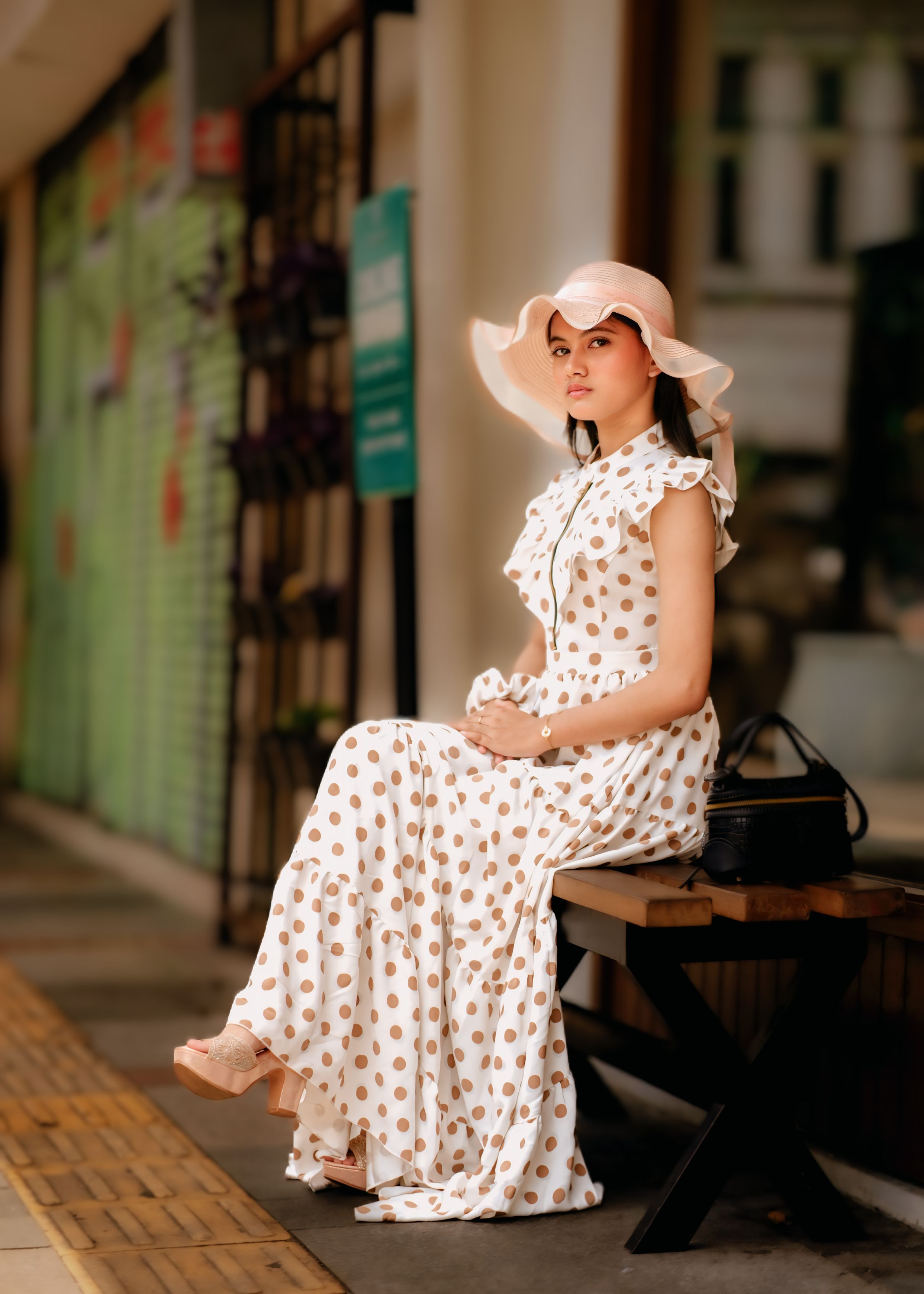 Elegant Woman in Polka Dot Dress Outdoors · Free Stock Photo