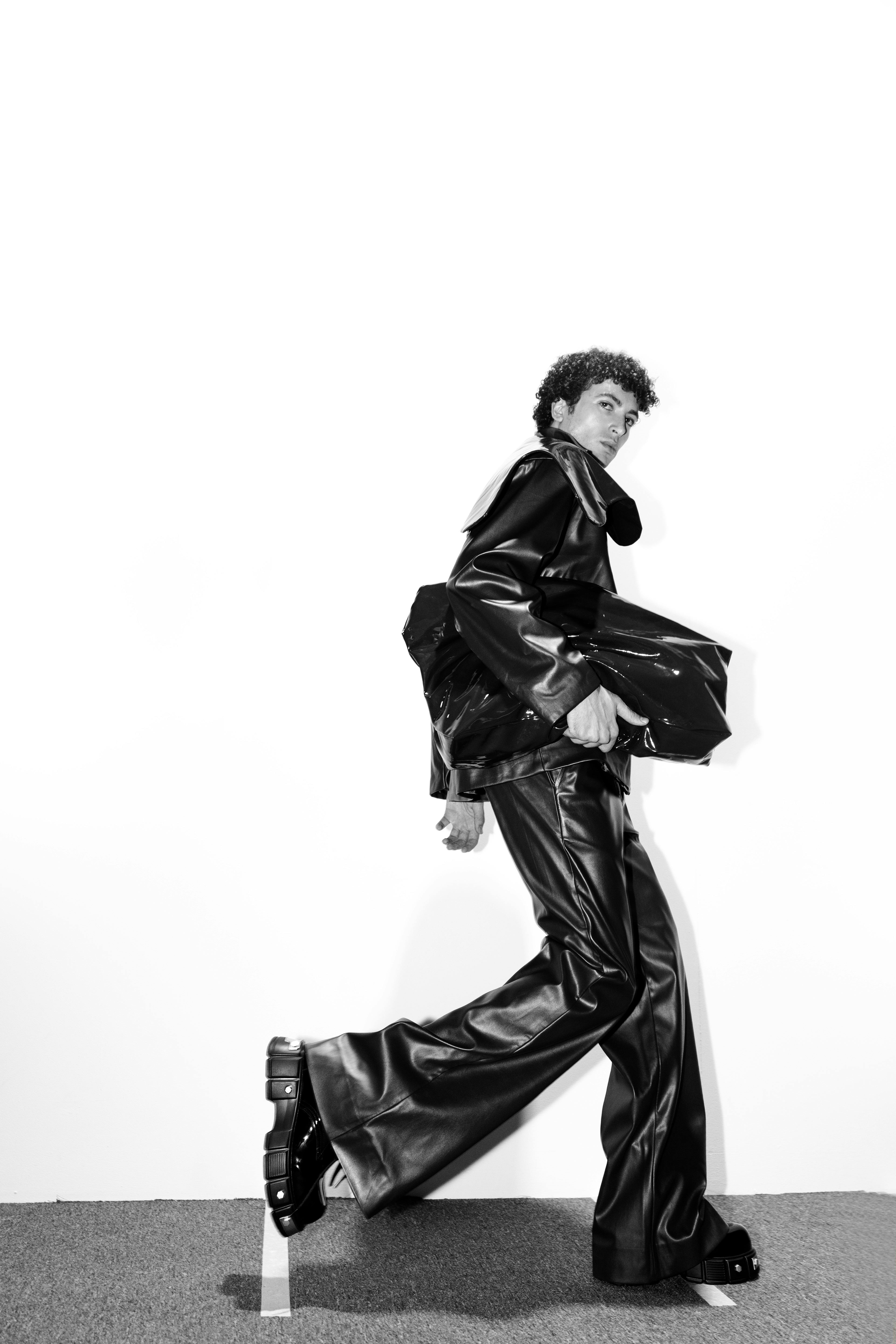 Energetic black and white portrait showcasing modern fashion in motion.