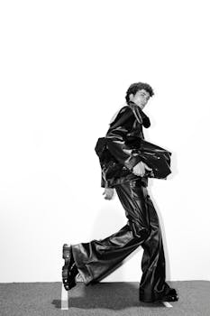 Energetic black and white portrait showcasing modern fashion in motion.