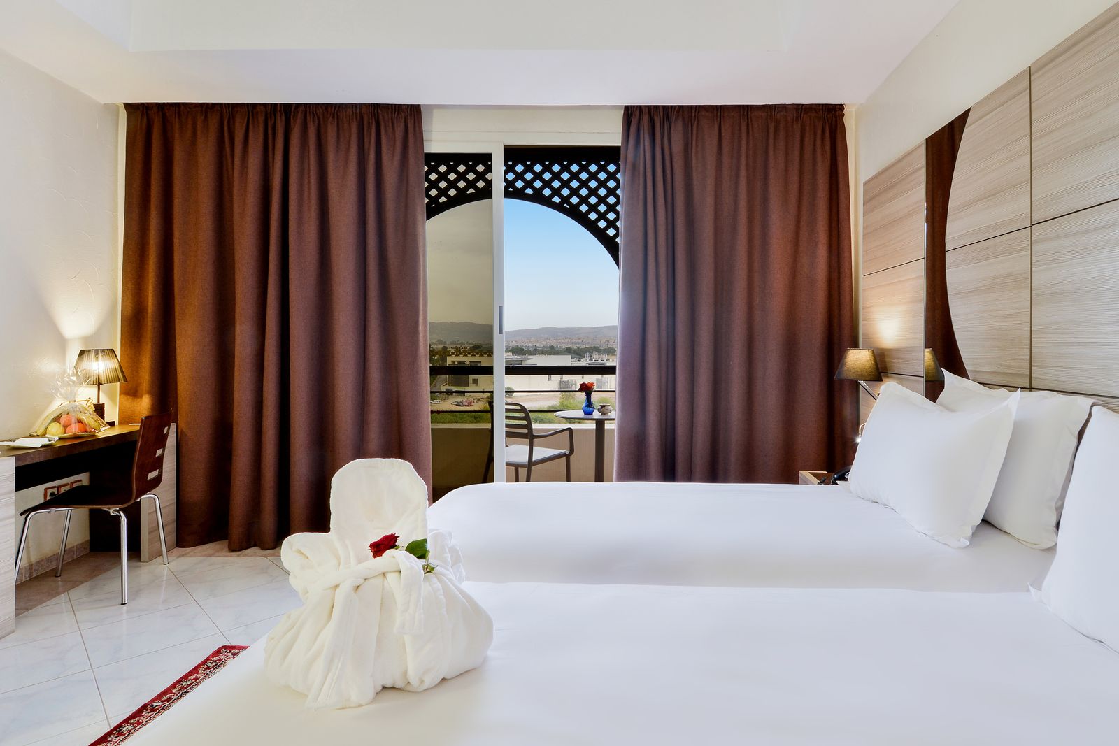 Junior Suite with a large bed and doors opening to a balcony view