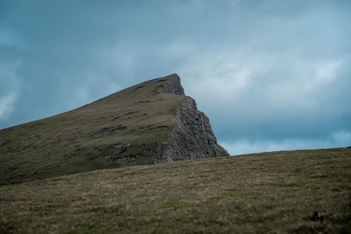 Free Majestic mountainous landscape in the Faroe Islands under a cloudy sky, perfect for nature enthusiasts. Stock Photo