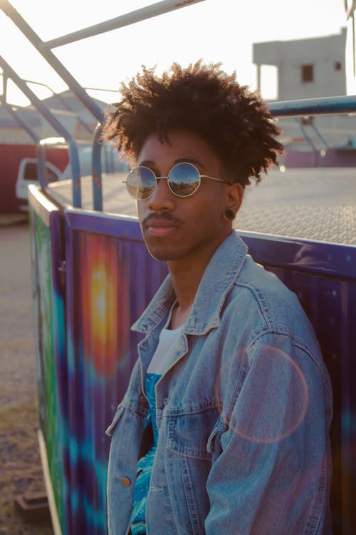 Man Wearing Blue Denim Jacket and Sunglasses