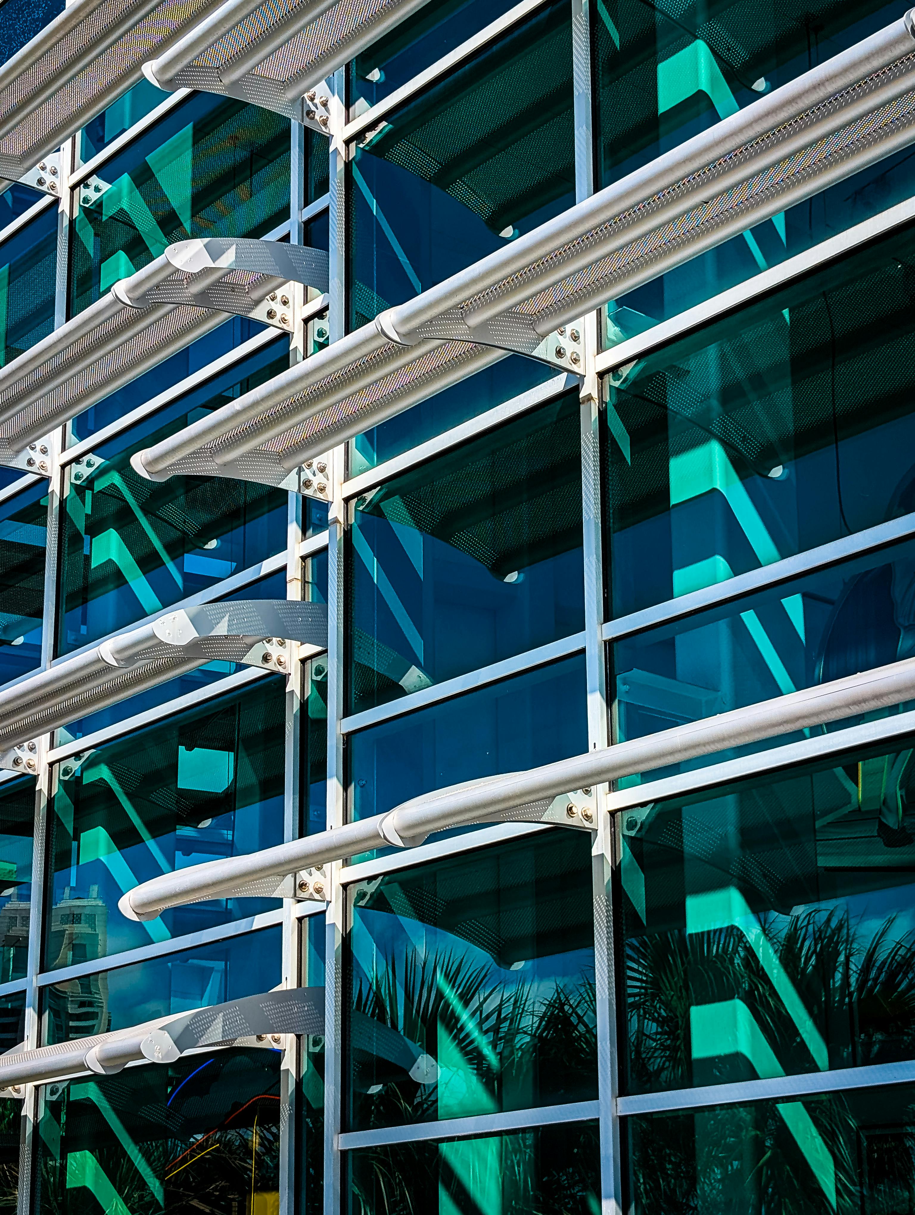 Contemporary glass facade with geometric patterns in Tampa, Florida, reflecting the urban environment.
