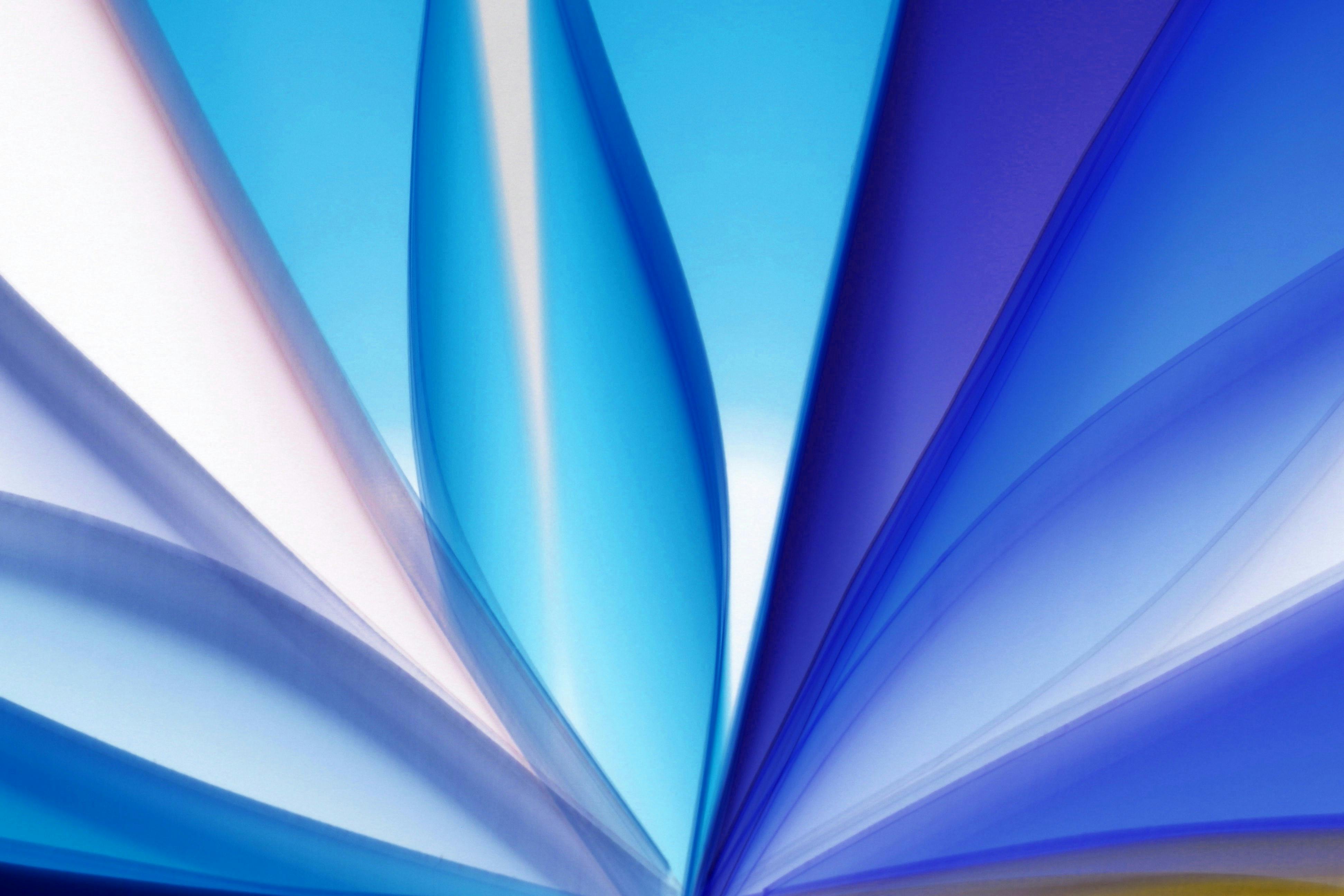 Vibrant abstract image featuring dynamic blue and white light streaks creating a modern pattern.