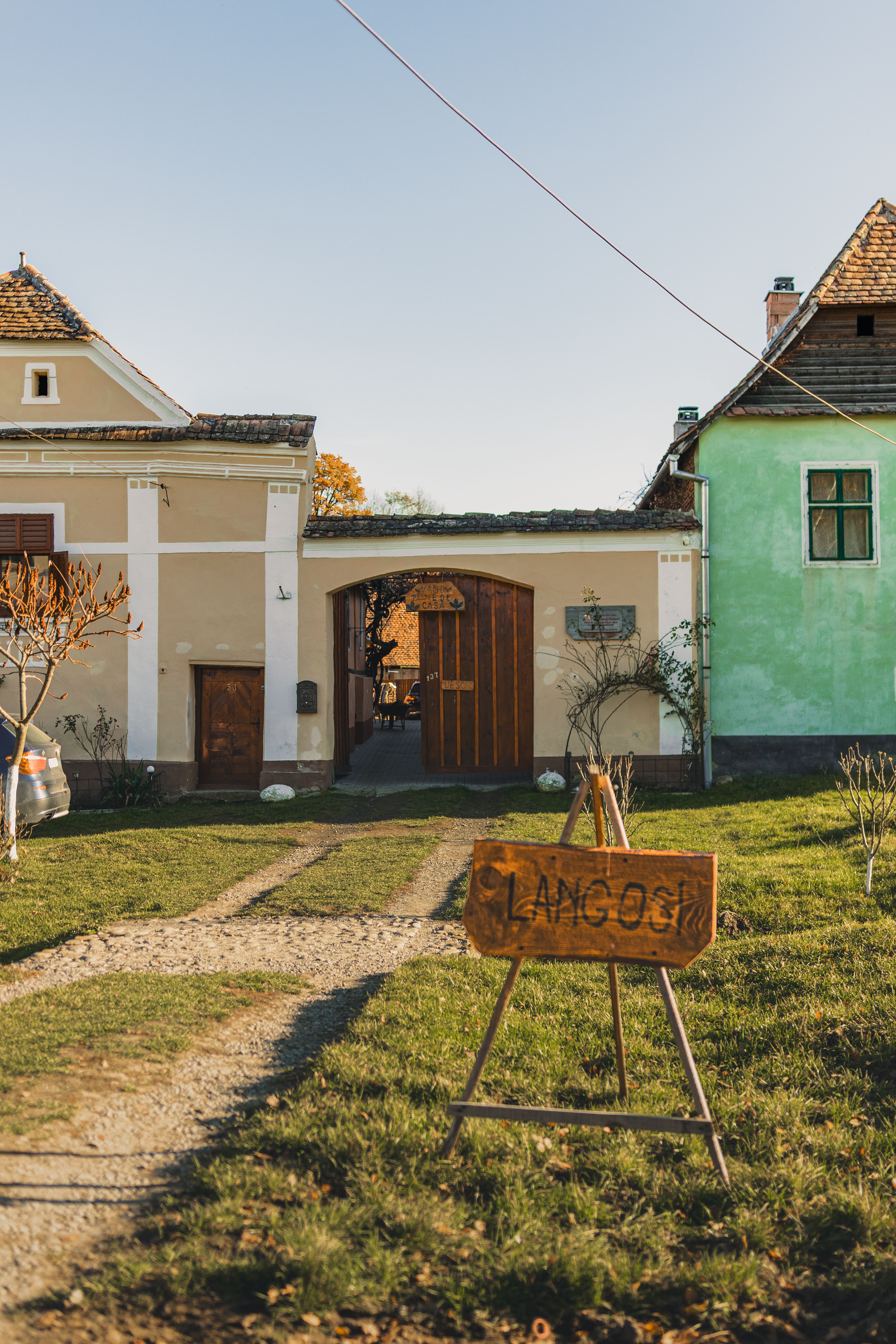 Idyllic rural house front with a Langos stand, capturing a peaceful countryside vibe.