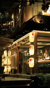 Warm, inviting exterior of a Japanese restaurant glowing in the night light.