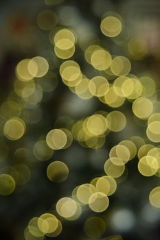 Abstract image of golden bokeh lights creating a festive atmosphere.