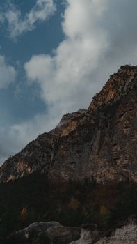 Stunning rocky cliff against a cloudy sky in North Ossetia, Russia.