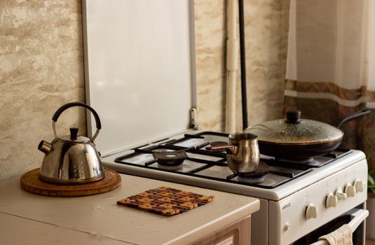 A traditional kitchen stove with a kettle and pan, creating a warm, homey ambiance.