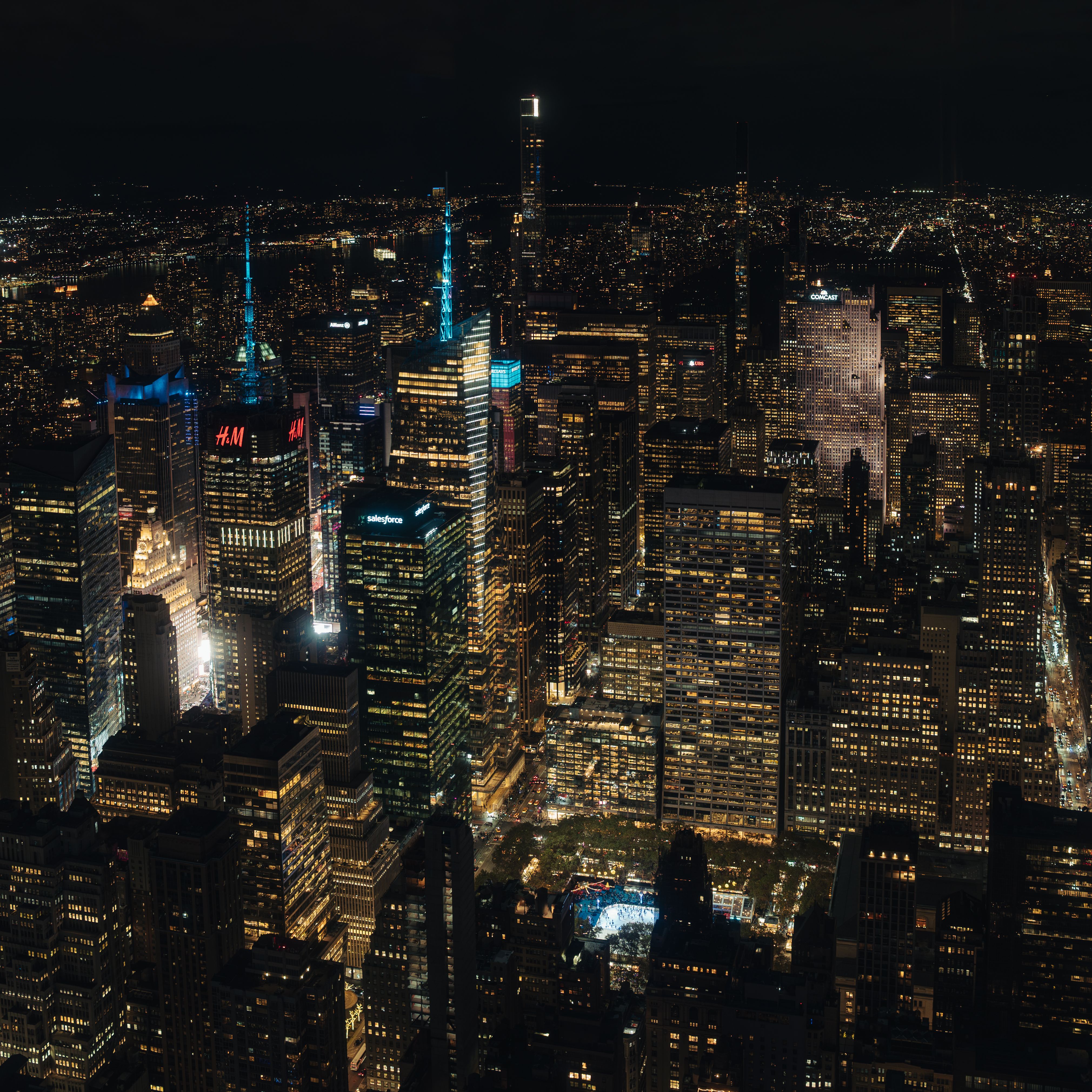 A breathtaking aerial view of New York City's illuminated skyline at night, showcasing iconic skyscrapers and city lights.