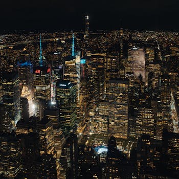 A breathtaking aerial view of New York City's illuminated skyline at night, showcasing iconic skyscrapers and city lights.