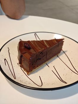 Delicious chocolate cake slice on a stylish plate, perfect for dessert lovers.